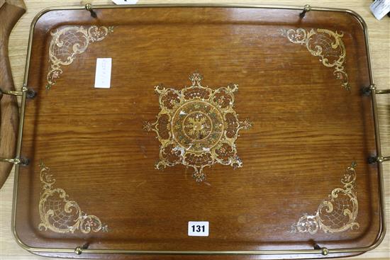 A Wooden tray with handles and brass surround